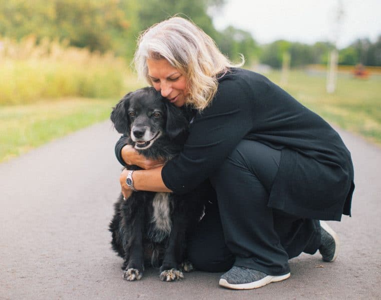 Woman hugging a dog in comfort