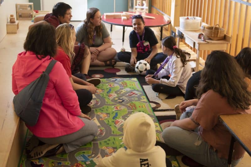 Youth sitting in a circle during a grief workshop.