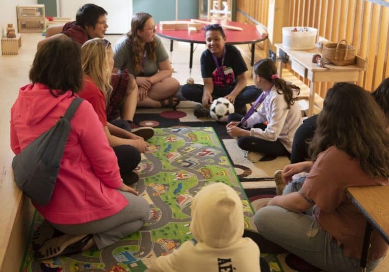 Youth sitting in a circle during a grief workshop.