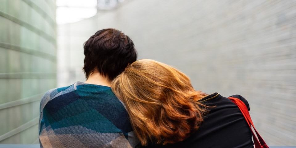 People leaning together in comfort and support