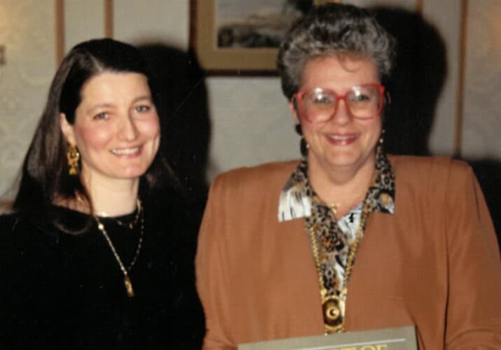 Two women smiling in an older, undated photo